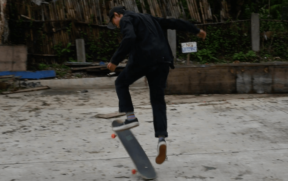 Filipino skater boy doing a trick in burnham park baguio city philippines